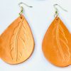 tear drop orange metallic leather earrings feather